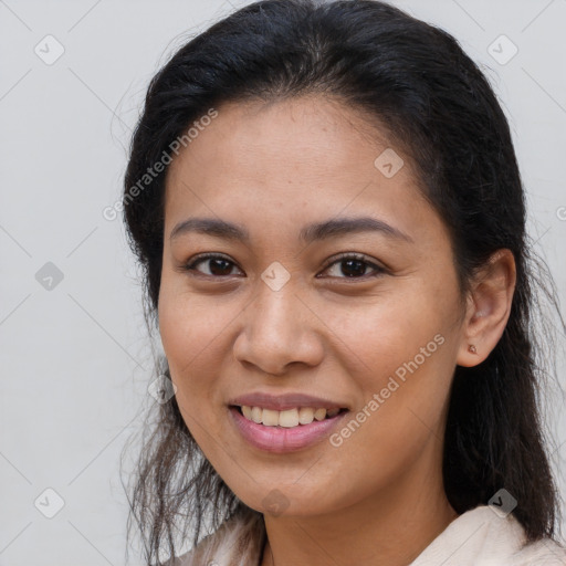 Joyful latino young-adult female with long  brown hair and brown eyes