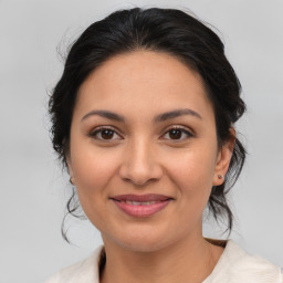 Joyful latino young-adult female with medium  brown hair and brown eyes