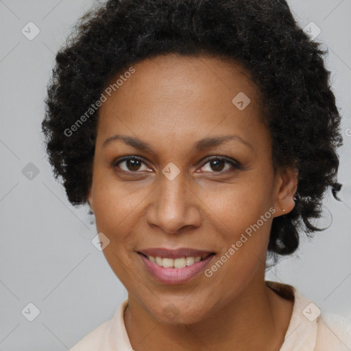 Joyful black adult female with short  brown hair and brown eyes