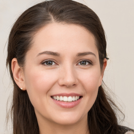 Joyful white young-adult female with long  brown hair and grey eyes