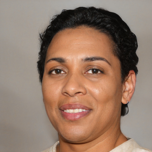 Joyful latino young-adult female with short  black hair and brown eyes