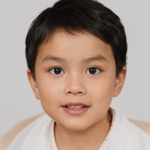 Joyful white child male with short  brown hair and brown eyes