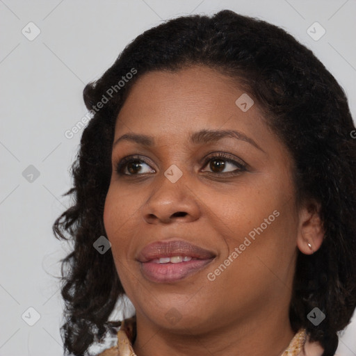 Joyful black adult female with medium  brown hair and brown eyes