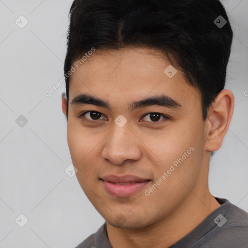 Joyful latino young-adult male with short  brown hair and brown eyes