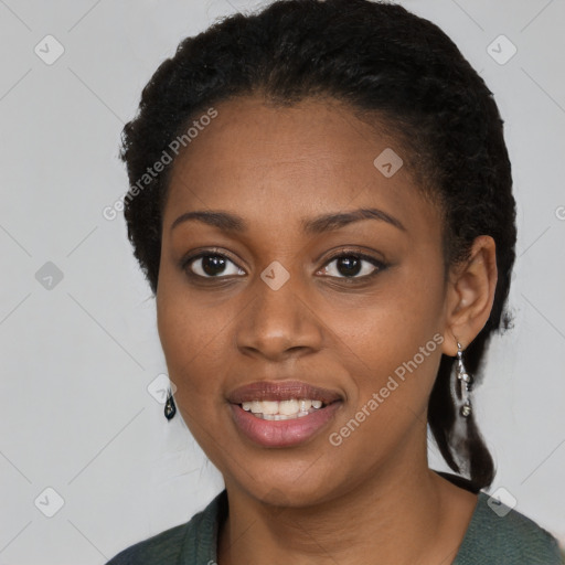 Joyful black young-adult female with long  black hair and brown eyes