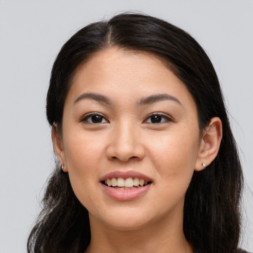 Joyful white young-adult female with long  brown hair and brown eyes