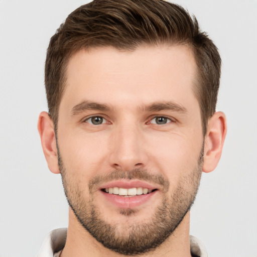 Joyful white young-adult male with short  brown hair and brown eyes