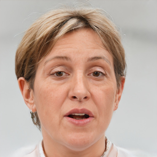 Joyful white middle-aged female with short  brown hair and grey eyes