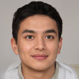 Joyful asian young-adult male with short  brown hair and brown eyes