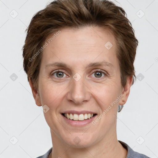 Joyful white adult female with short  brown hair and grey eyes