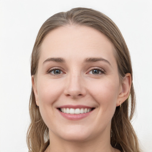 Joyful white young-adult female with long  brown hair and grey eyes