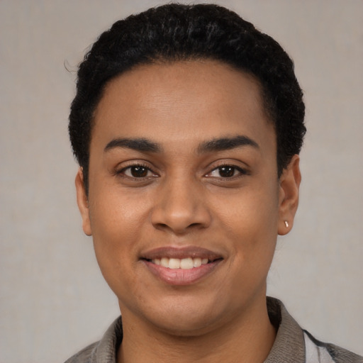 Joyful latino young-adult female with short  black hair and brown eyes