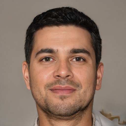 Joyful white adult male with short  brown hair and brown eyes