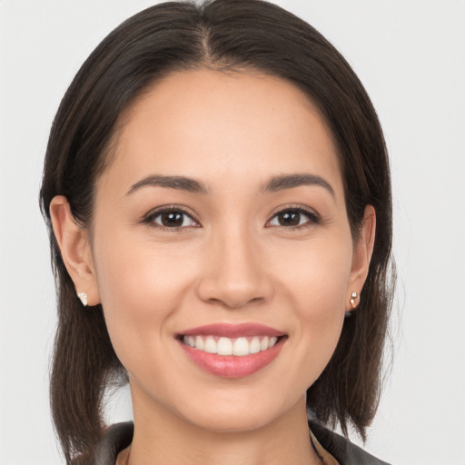 Joyful white young-adult female with long  brown hair and brown eyes