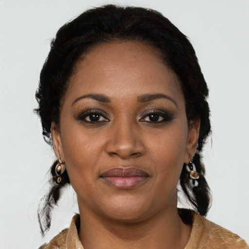 Joyful black young-adult female with long  black hair and brown eyes