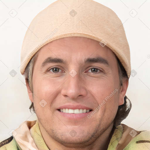 Joyful white adult male with short  brown hair and grey eyes