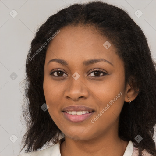 Joyful black young-adult female with long  brown hair and brown eyes