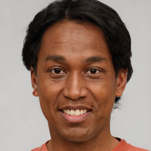 Joyful asian adult male with short  black hair and brown eyes