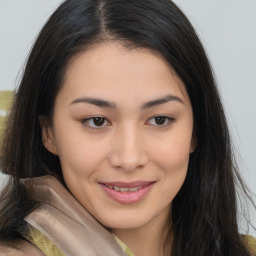 Joyful asian young-adult female with long  brown hair and brown eyes