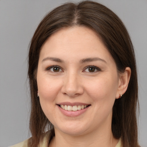 Joyful white young-adult female with medium  brown hair and brown eyes