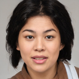 Joyful asian young-adult female with medium  brown hair and brown eyes