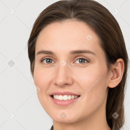 Joyful white young-adult female with medium  brown hair and grey eyes