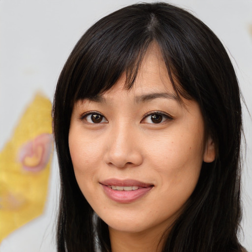 Joyful asian young-adult female with long  brown hair and brown eyes
