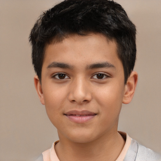 Joyful latino child male with short  brown hair and brown eyes