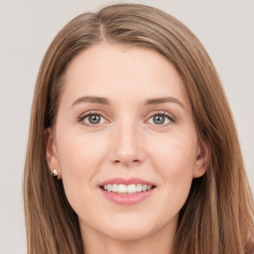 Joyful white young-adult female with long  brown hair and grey eyes