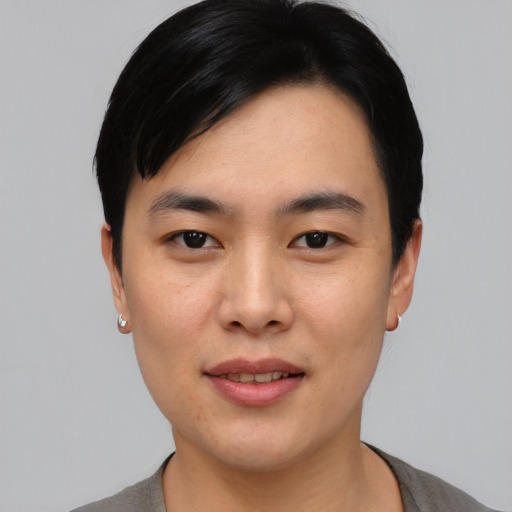 Joyful asian young-adult male with short  black hair and brown eyes
