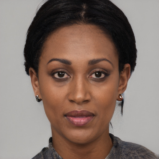Joyful black young-adult female with medium  black hair and brown eyes