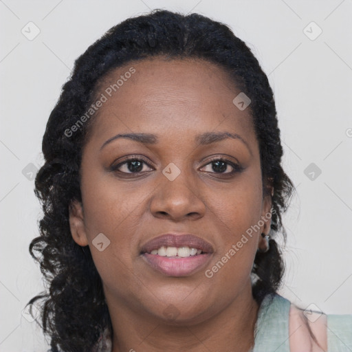 Joyful black young-adult female with long  brown hair and brown eyes