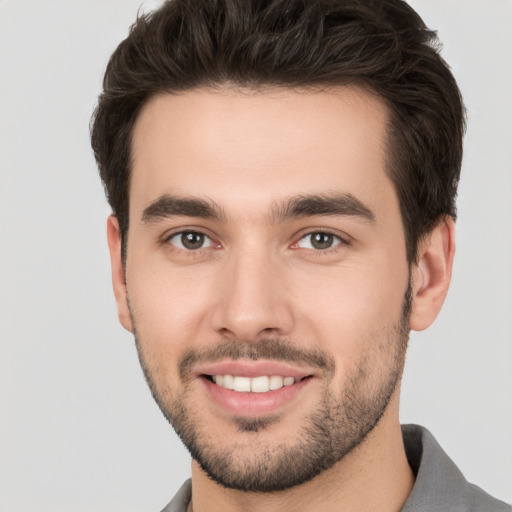 Joyful white young-adult male with short  brown hair and brown eyes