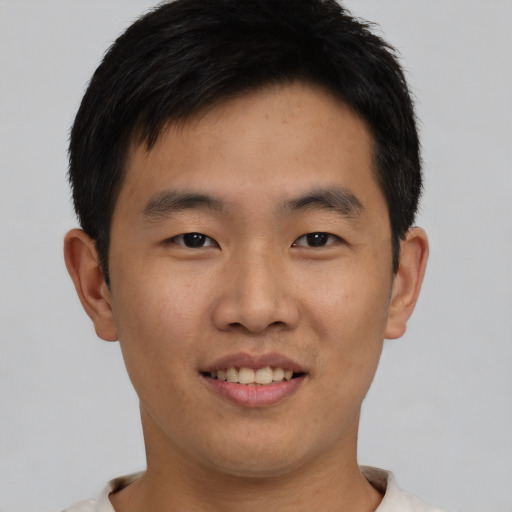 Joyful asian young-adult male with short  black hair and brown eyes