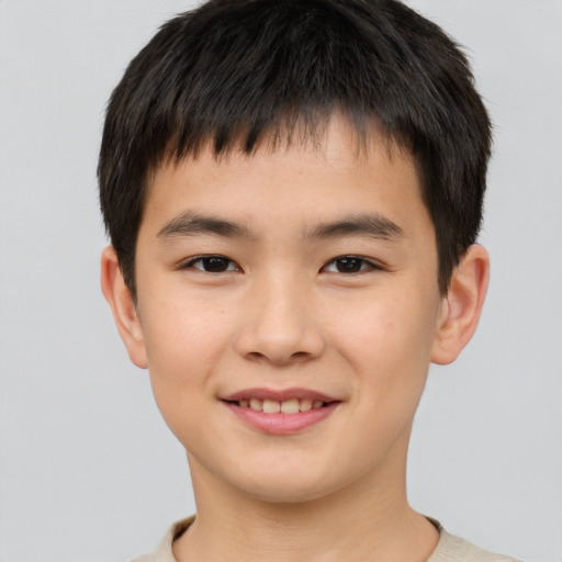 Joyful asian child male with short  brown hair and brown eyes