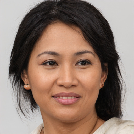 Joyful asian adult female with medium  brown hair and brown eyes
