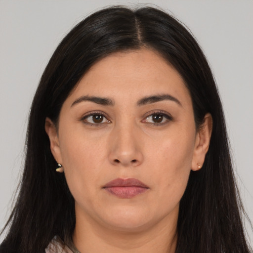 Neutral latino young-adult female with long  brown hair and brown eyes