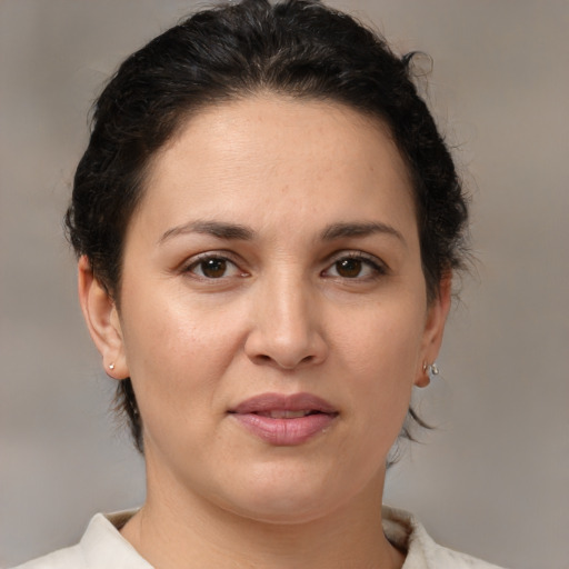 Joyful white adult female with medium  brown hair and brown eyes