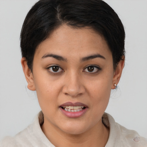 Joyful asian young-adult female with short  brown hair and brown eyes