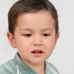 Joyful white child male with short  brown hair and brown eyes