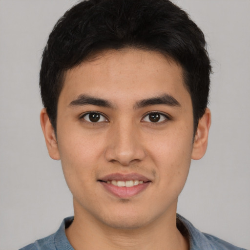 Joyful latino young-adult male with short  black hair and brown eyes