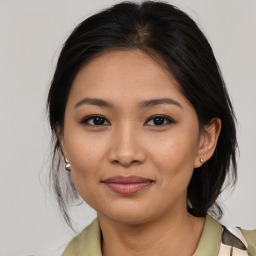 Joyful asian young-adult female with medium  brown hair and brown eyes