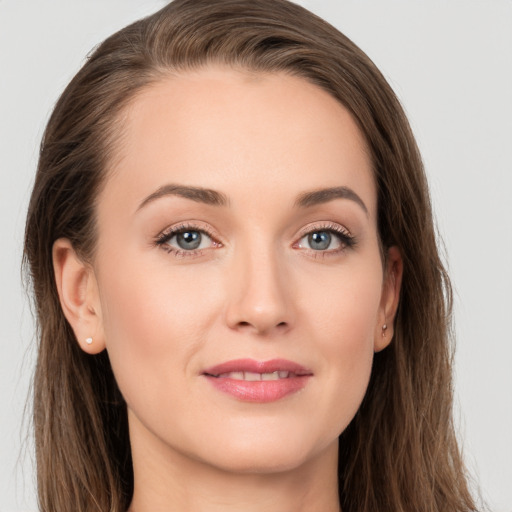 Joyful white young-adult female with long  brown hair and grey eyes