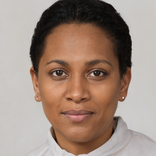 Joyful black young-adult female with short  black hair and brown eyes