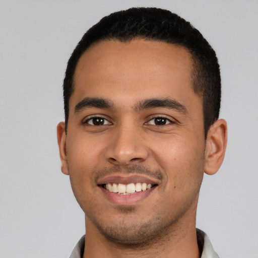 Joyful latino young-adult male with short  black hair and brown eyes