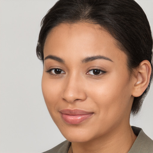 Joyful latino young-adult female with long  brown hair and brown eyes