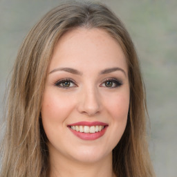 Joyful white young-adult female with long  brown hair and green eyes