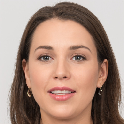 Joyful white young-adult female with long  brown hair and grey eyes