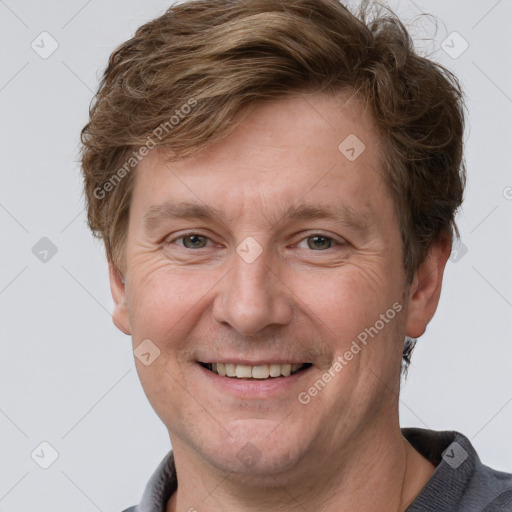 Joyful white adult male with short  brown hair and grey eyes