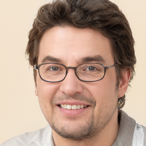 Joyful white adult male with short  brown hair and green eyes